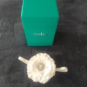 Empty Tieks Box and white flower topper